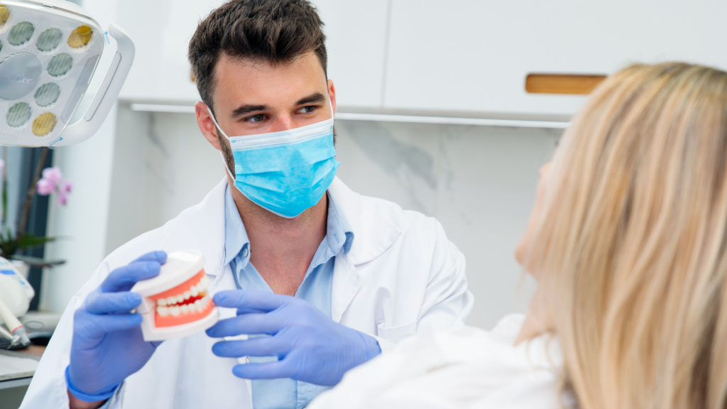 A dentist showing a patient a high-quality, tooth-colored composite resin that is certified BPA-free and biocompatible.