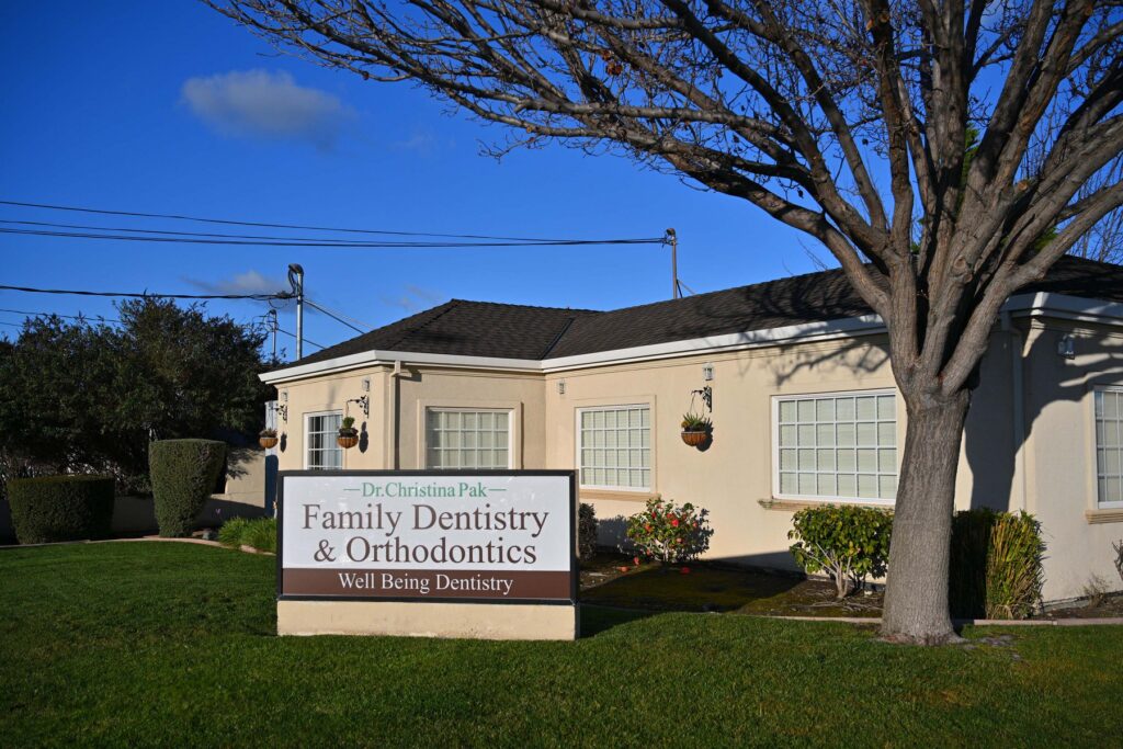 The exterior of Dr. Christina Pak’s Wellbeing Dentistry office in Santa Clara, CA, featuring a clear sign for Family Dentistry & Orthodontics.