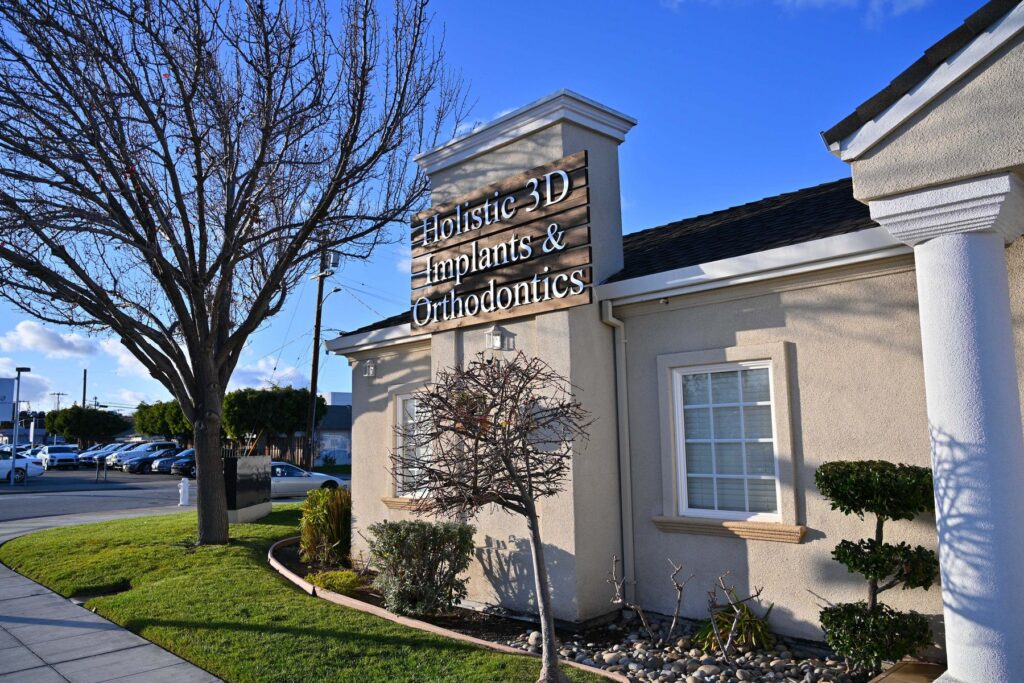 A curated display of holistic oral care products at Wellbeing Dentistry in Santa Clara, CA, featuring Invisalign information, Myobrace for juniors, and biological health kits.