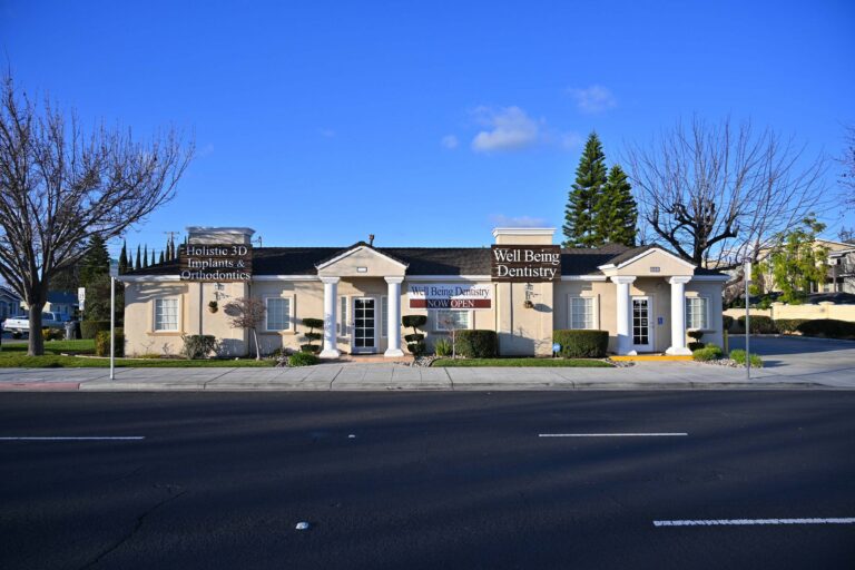 The exterior view of the Well Being Dentistry office in Santa Clara, CA, featuring signage for "Holistic 3D Implants & Orthodontics".