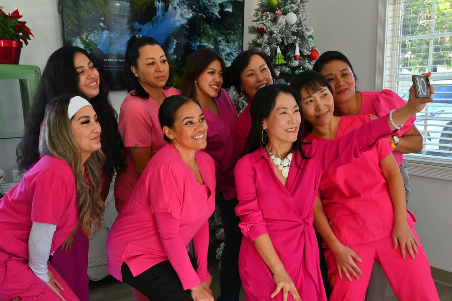 A professional and warm group portrait of the Well Being Dentistry clinical team in a modern, calming office setting, radiating expertise and empathy.