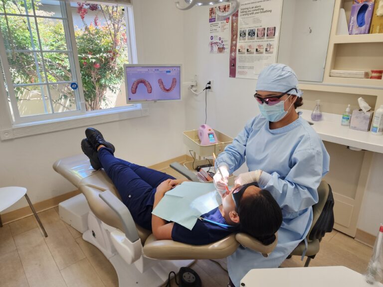 Dr. Christina Pak performs a detailed biological dental procedure at Wellbeing Dentistry in Santa Clara, CA, utilizing advanced clinical technology.